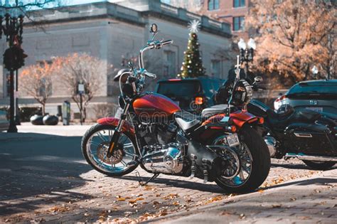 Two Motorcycles Parked On The Side Of A Road In Downtown Fayetteville