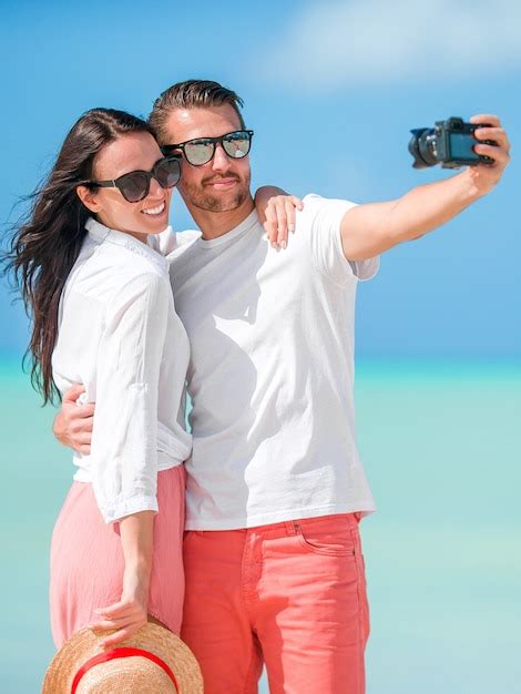 Premium Photo Happy Couple Taking A Selfie Photo On White Beach Two