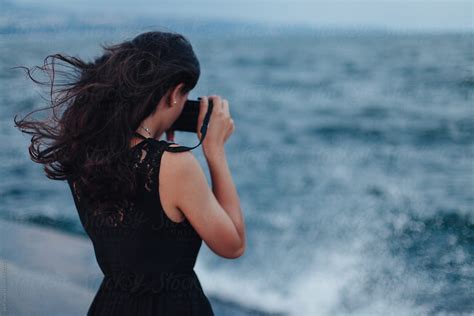 Back Of A Young Woman Taking A Picture Of The Sea By Stocksy Contributor Paff Stocksy