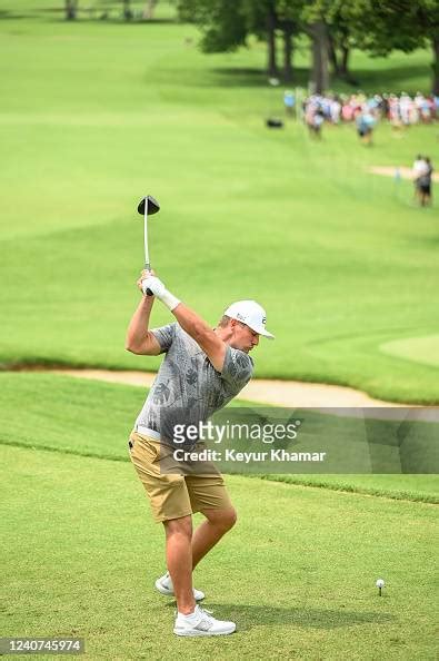 Bryson Dechambeau At The Top Of His Swing As He Plays His Shot From