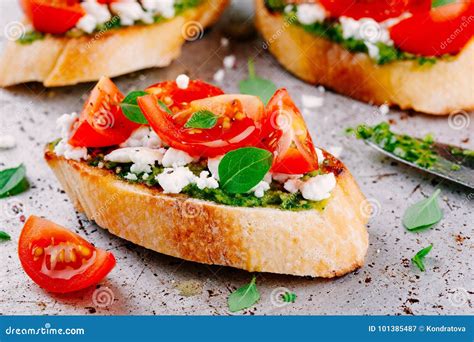 Bruschetta With Pesto Sauce Feta Cheese Tomatoes And Basil Stock