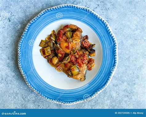 Bonito Fish Pieces With Tomato Sauce And Leek In Plate Baked In Oven