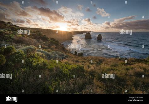 Person watching sunset at the Twelve Apostles Australia Stock Photo - Alamy