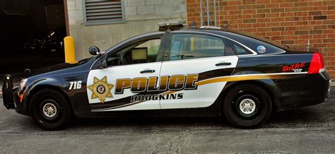 A Police Car Parked In Front Of A Brick Building