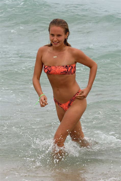 Sailor Brinkley Cook Wears An Orange Snakeskin Print Bikini During A