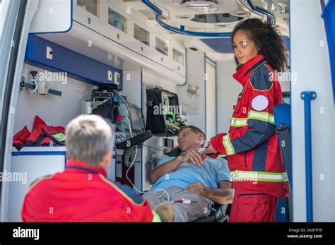 Paramedics Monitoring A Patient Oxygenation Status In The EMS Van Stock