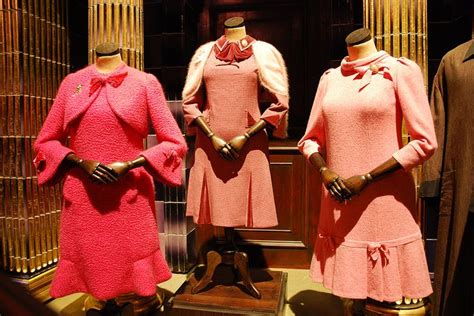 Three Mannequins Dressed In Pink Dresses And Hats