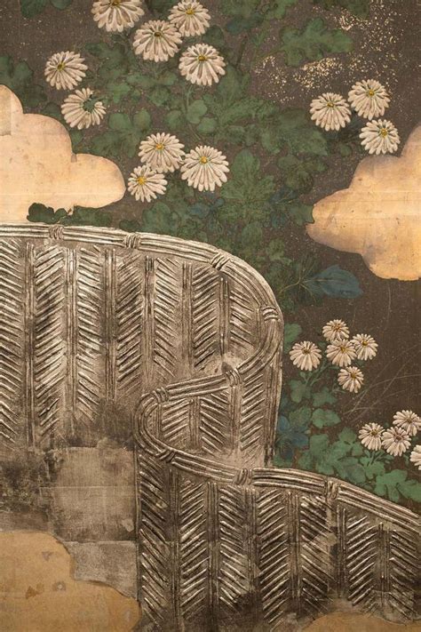 a drawing of a chair and flowers on a wall with clouds in the sky behind it