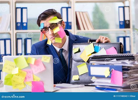 The Businessman With Reminder Notes In Multitasking Concept Stock Photo