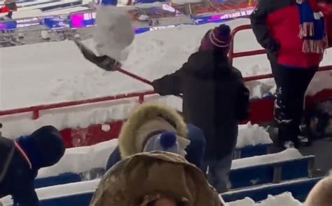 Bills Fans Dig Their Seats Out From The Snow In The Stands