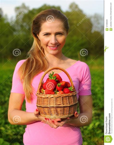 Basket Of Strawberries Held By Young Woman Out Of Focus With S Stock