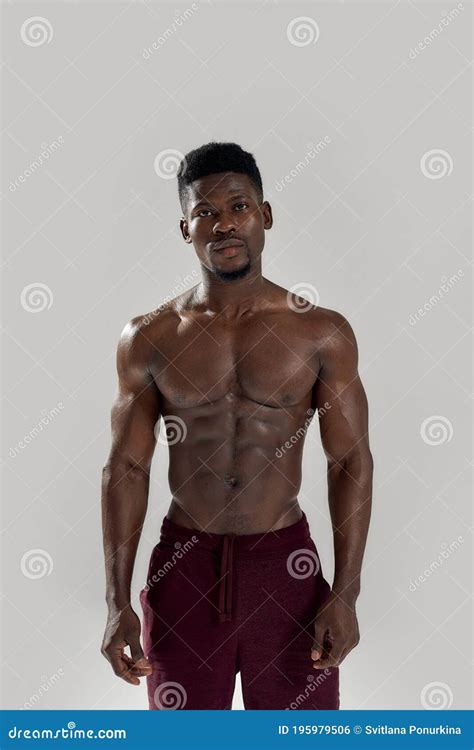 Strength Muscular African American Man Looking At Camera Showing His