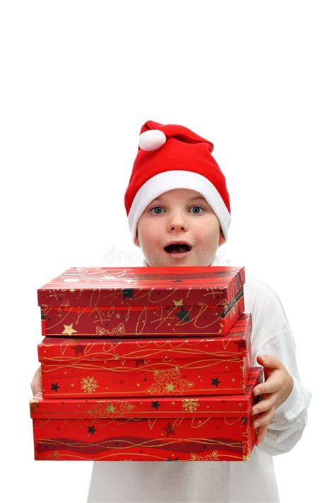 Small Boy In Santa Red Hat Carrying Three Presents Stock Photo Image