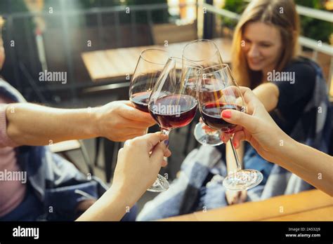 People Clinking Glasses With Wine On The Summer Terrace Of Cafe Or Restaurant Happy Cheerful