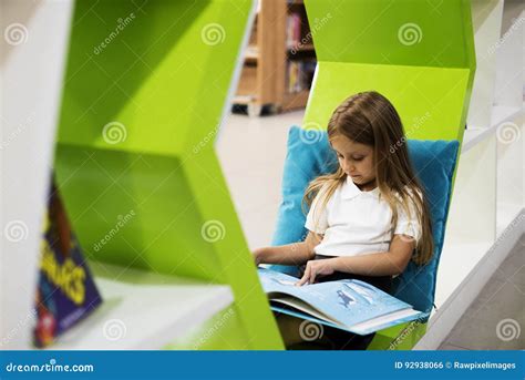 Young Girl Reading Children Story Book in Library Stock Photo - Image of girl, reading: 92938066