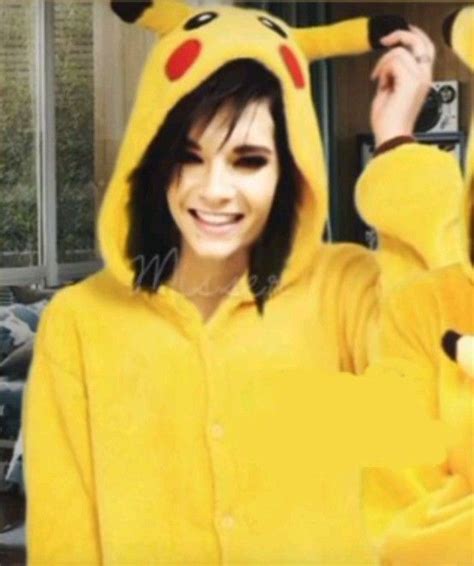 A Woman In A Pikachu Costume Is Smiling And Holding Her Hand Up To Her Head