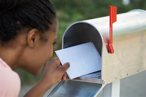 Close Up Of Woman Putting Letter In Mailbox Pamela Grow