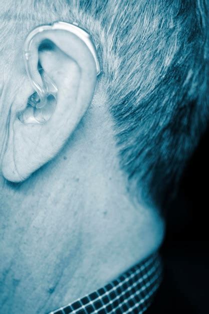 Premium Photo Close Up Man Wearing Hearing Aid