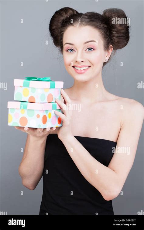 Happy Brunette Woman In Dress Holding Present T Box And Looking At The Camera While Enjoys On