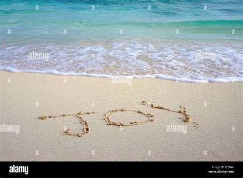 Joy Written In The Sand On The Beach Stock Photo Alamy