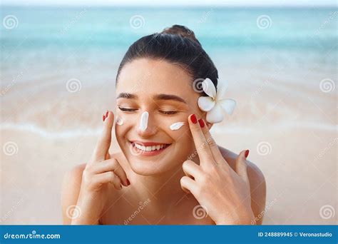 Beautiful Woman Applying Cream Sunscreen On A Tanned Face Sunscreen