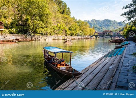 Parked Wooden Tourist Boat On The Tuojiang River And Amazing Bridge