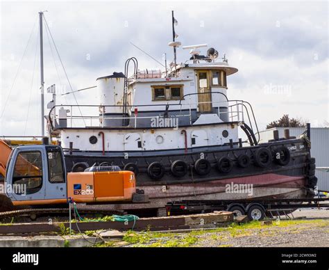 Old tug boat taken out of the water for dismemberment -1 Stock Photo - Alamy