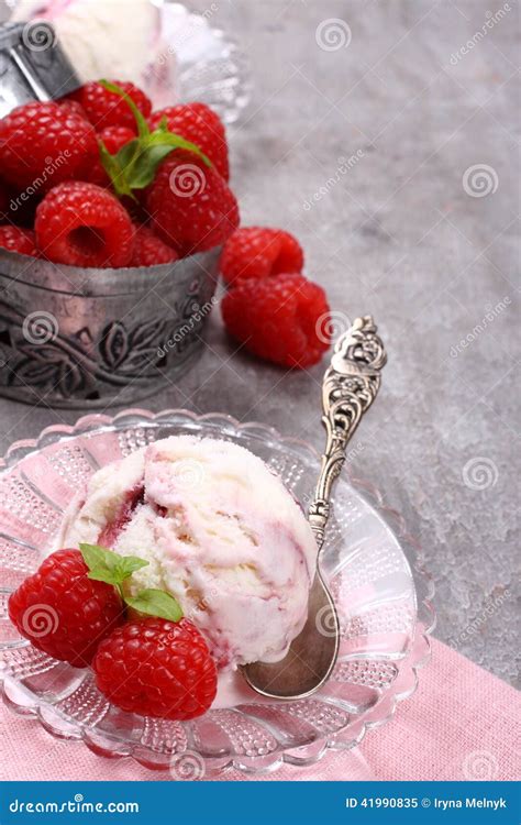 Homemade Berry Ice Cream Decorated With Fresh Raspberries On Old Gray