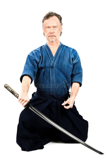 Caucasian Male Training Japanese Sport Iaido Sitting On Floor Holding