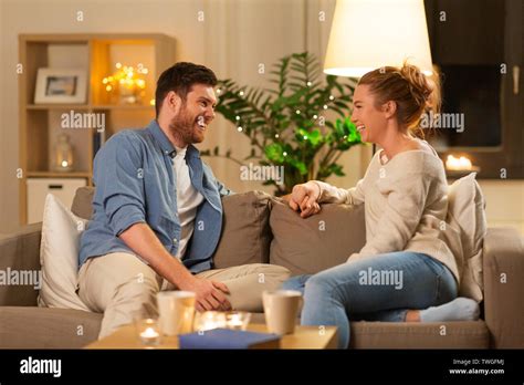 Happy Couple Talking At Home In Evening Stock Photo Alamy