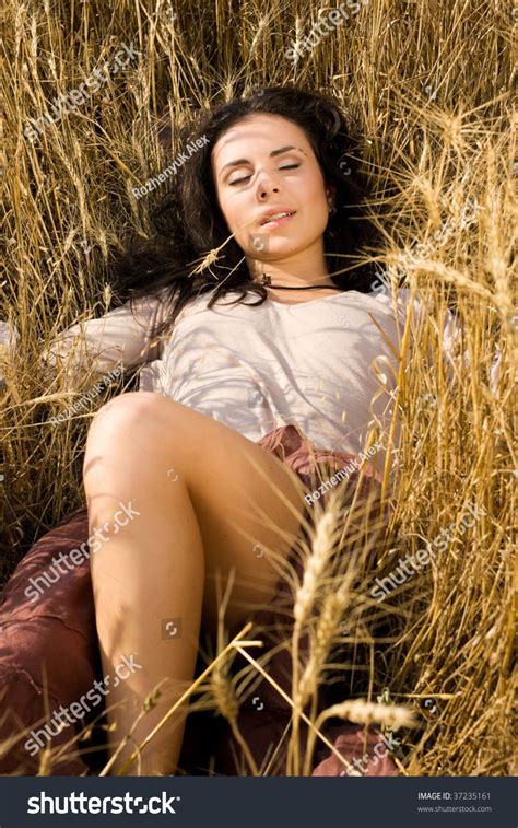 Attractive Girl Lying In Golden Wheat Field Stock Photo 37235161