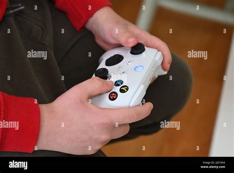 A young boy holding an xbox controller Stock Photo - Alamy