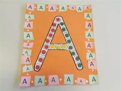 The Letter A Is Made Out Of Construction Paper And Colored Dots On An