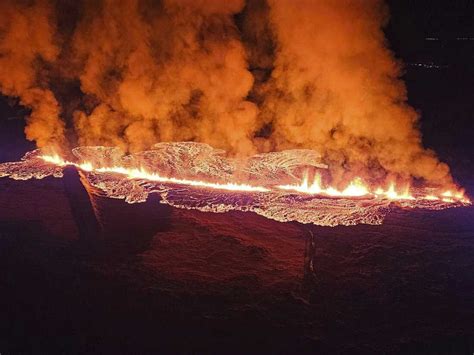 A volcano erupts in Iceland, sending lava flowing toward a nearby town ...