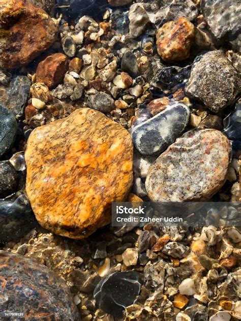 Colourful Stones In Riverbed Stock Photo Download Image Now Pebble