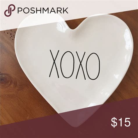 A Heart Shaped Dish With The Word Xoxo Written On It For 15