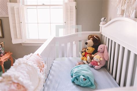 Newborn baby sleeping in a crib — Photo — Lightstock