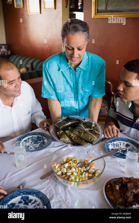 Mature Couple And Their Son At A Dining Table Stock Photo Alamy