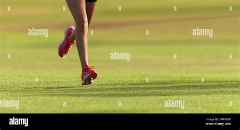 Runner Athlete Feet Running On Grass Female Fitness Sunlight Jogging