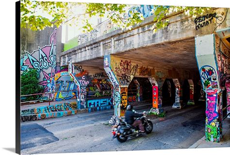 A Motorcyclist Enters The Graffiti Covered Krog Street Tunnel In