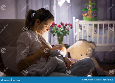 Young Beautiful Mother Breastfeeding Her Newborn Baby Boy At Ni Stock