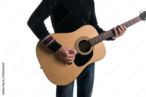 A Guitarist In Jeans And A Black Sweater Plays An Acoustic Guitar With