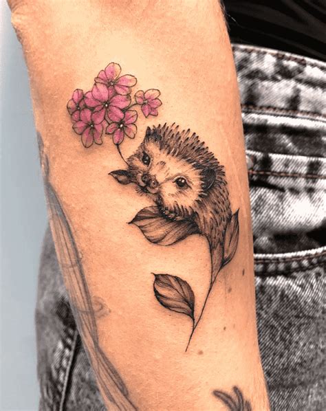 A Hedgehog With Flowers On Its Head Is Shown In This Tattoo Artists Photo