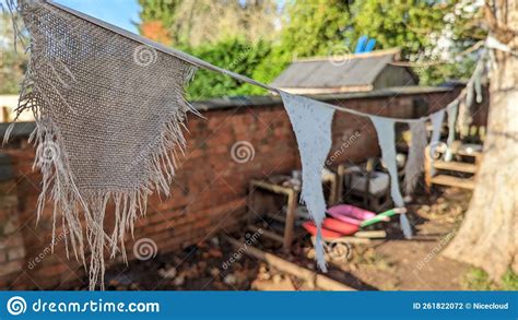 Fraid Worn Hessian Bunting Flags Hanging Between Two Trees Stock Photo