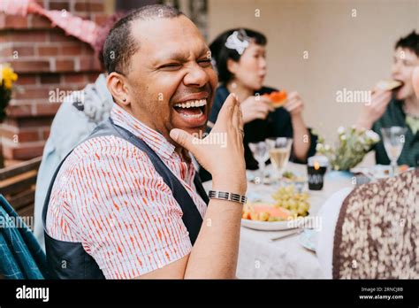 Cheerful Gay Man Laughing While Enjoying During Party With Friends In
