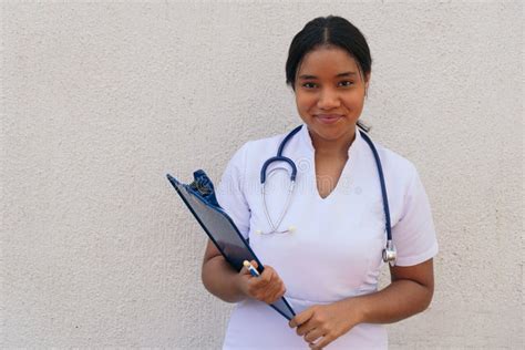 Portrait Of Latina Nurse With Clipboard At Work In Hospital Stock Photo Image Of Healthcare