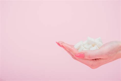 Premium Photo Cropped View Of Woman With Handful Of White Sugar Cubes