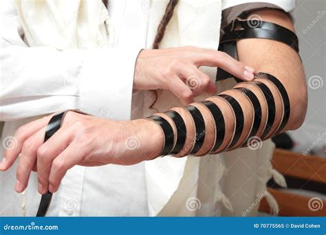 Un Judío Ortodoxo Religioso Con El Brazo tefillin En Su Mano Izquierda