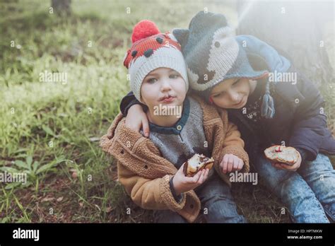 Two Boys Eating Berliners In Forest 2 3 Years Hi Res Stock Photography