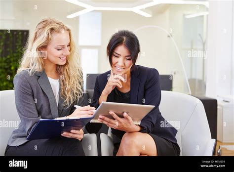 Two Business Women With Tablet During Business Consulting Planning